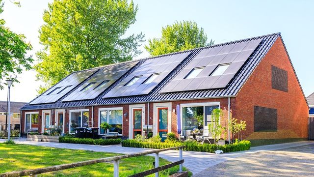 A house with rooftop solar panels installed.