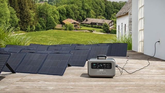 A portable solar generator sitting on a wooden deck.