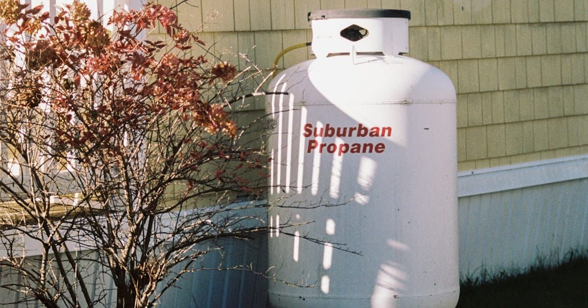 A white backup power unit sited next to a house.